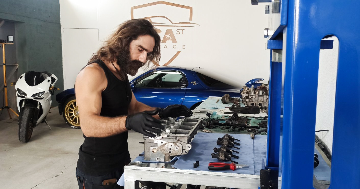 Marius rebuilding a cylinder head at the L.C.A Street Garage workbench in Livadia, Larnaca